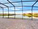 Spacious screened patio overlooking a serene lake, perfect for enjoying tranquil views at 3774 Eagle Isle Cir, Kissimmee, FL 34746