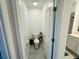 Modern bathroom with a toilet and vanity sink at 4295 Twisted Twig Bnd, Kissimmee, FL 34746