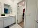 Clean bathroom with modern sink, vanity, and walk-in closet at 4295 Twisted Twig Bnd, Kissimmee, FL 34746