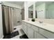 Bathroom featuring a double vanity, modern fixtures, and a tiled shower at 4295 Twisted Twig Bnd, Kissimmee, FL 34746