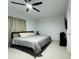 Simple bedroom with a comfortable bed, ceiling fan, and modern amenities at 4295 Twisted Twig Bnd, Kissimmee, FL 34746