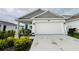 Charming home with a two-car garage, blue door, and tastefully landscaped front yard at 4295 Twisted Twig Bnd, Kissimmee, FL 34746