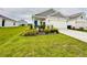 Well-manicured lawn and garden beds enhance the curb appeal of this lovely single Gathering home at 4295 Twisted Twig Bnd, Kissimmee, FL 34746