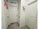 Hallway with multiple closets, white doors, and neutral gray flooring at 4295 Twisted Twig Bnd, Kissimmee, FL 34746