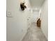 Hallway with ceramic tile floors and decor leading to rooms in the house at 4295 Twisted Twig Bnd, Kissimmee, FL 34746