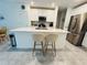 Modern kitchen featuring a large island, bar stool seating, and stainless steel appliances at 4295 Twisted Twig Bnd, Kissimmee, FL 34746