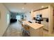 Modern kitchen features an island with seating, stainless steel appliances, and an open floor plan at 4295 Twisted Twig Bnd, Kissimmee, FL 34746