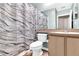 Compact bathroom with a single sink vanity, toilet, and shower with patterned curtain at 4356 S Kirkman Rd # 514, Orlando, FL 32811
