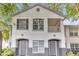 Charming condo featuring a white stucco exterior, gray accents, and a cozy second-story balcony at 4356 S Kirkman Rd # 514, Orlando, FL 32811