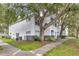 View of condo exterior and lawn showing trees, landscaping, and building design at 4356 S Kirkman Rd # 514, Orlando, FL 32811