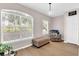 Bright living room with large windows, modern armchair, and stylish decor creates a welcoming atmosphere at 4356 S Kirkman Rd # 514, Orlando, FL 32811