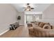 Cozy living room featuring hardwood floors, a fan, and a large window for natural light at 4356 S Kirkman Rd # 514, Orlando, FL 32811