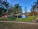 A scenic pond surrounded by trees and landscaping, with a brick walkway leading to the water at 4356 S Kirkman Rd # 514, Orlando, FL 32811