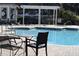 Community pool featuring lounge seating and a pergola with a view of additional buildings and landscaping at 4356 S Kirkman Rd # 514, Orlando, FL 32811