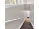 Interior staircase leading to the ground floor with handrail and bright natural light at 4356 S Kirkman Rd # 514, Orlando, FL 32811