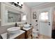 Bathroom featuring a double vanity, neutral colors, and tiled shower with custom accents at 4523 Wyndcliff Cir, Orlando, FL 32817