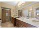 Bathroom with double vanity, a glass enclosed shower and lots of counter space at 4523 Wyndcliff Cir, Orlando, FL 32817