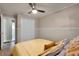 Bedroom featuring ceiling fan, wood floors, and double door closet at 4523 Wyndcliff Cir, Orlando, FL 32817