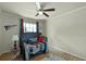 This bedroom features a ceiling fan, natural light, and sporty decor at 4523 Wyndcliff Cir, Orlando, FL 32817