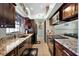Well-equipped kitchen with dark cabinets and granite countertops at 4523 Wyndcliff Cir, Orlando, FL 32817