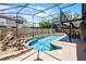 Beautiful screened-in pool area with waterfall feature and a fenced yard at 4523 Wyndcliff Cir, Orlando, FL 32817