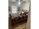 Comfortable bedroom featuring a wooden bed frame, soft bedding, and a bright window for natural light at 4805 Sw 171St Ct, Dunnellon, FL 34432