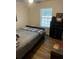 Simple bedroom featuring a well-made bed, a dark dresser, and natural light streaming through a window at 4805 Sw 171St Ct, Dunnellon, FL 34432