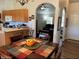Cozy dining area with a wooden table set with colorful placemats, conveniently located next to the kitchen at 4805 Sw 171St Ct, Dunnellon, FL 34432
