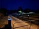 Gated entrance with illuminated driveway and fenced pastures at dusk at 4805 Sw 171St Ct, Dunnellon, FL 34432