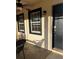 Inviting front entrance with stylish black trim windows and a ceiling fan for comfort on the porch at 4805 Sw 171St Ct, Dunnellon, FL 34432