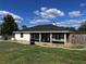 Cozy single-story home featuring a screened porch and freshly cut green lawn against a cloudy blue sky backdrop at 4805 Sw 171St Ct, Dunnellon, FL 34432