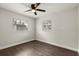 This bedroom features sleek wood flooring, a ceiling fan, and two windows for natural light at 500 Vereen Dr, Maitland, FL 32751