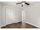 This bedroom features sleek wood flooring, a ceiling fan, and a large closet at 500 Vereen Dr, Maitland, FL 32751