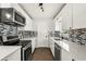 Modern kitchen featuring white cabinets, stainless steel appliances, and tile backsplash at 500 Vereen Dr, Maitland, FL 32751
