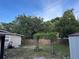 Backyard view of wooden fence and mature trees at 603 Zinnia Dr, Casselberry, FL 32707