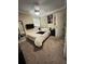 Inviting bedroom with soft carpeting, a bed, a window, and a black dresser at 603 Zinnia Dr, Casselberry, FL 32707
