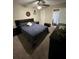 Cozy bedroom with carpet flooring, a ceiling fan, and a view into the bathroom at 603 Zinnia Dr, Casselberry, FL 32707
