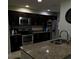 Well-equipped kitchen featuring dark wood cabinetry and stainless steel appliances at 603 Zinnia Dr, Casselberry, FL 32707