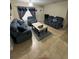 Cozy living room featuring plush sofas, a decorative rug, and ample natural light at 603 Zinnia Dr, Casselberry, FL 32707
