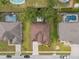 Aerial view of home in a neighborhood with fenced backyard pools at 813 Lancer Cir, Ocoee, FL 34761