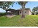 Home exterior with large backyard and screened in lanai at 813 Lancer Cir, Ocoee, FL 34761