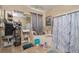 Bathroom with cluttered shelving and marble-patterned shower curtain at 813 Lancer Cir, Ocoee, FL 34761
