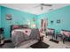 Bedroom with blue walls, ceiling fan, and black and white accents at 813 Lancer Cir, Ocoee, FL 34761