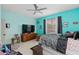 Bedroom with blue walls, a ceiling fan, and a mounted television at 813 Lancer Cir, Ocoee, FL 34761
