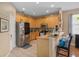 Eat-in kitchen with stainless steel refrigerator and light wood cabinets at 813 Lancer Cir, Ocoee, FL 34761
