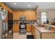 Kitchen with stainless steel appliances, tiled floor and light wood cabinets at 813 Lancer Cir, Ocoee, FL 34761