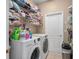 Convenient laundry room with washer, dryer, and ample storage shelving at 813 Lancer Cir, Ocoee, FL 34761