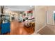 Open-concept living room with hardwood floors, showcasing seamless transition to dining area, great for entertaining at 813 Lancer Cir, Ocoee, FL 34761