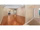 Spacious living room featuring gleaming hardwood floors and an open floor plan into the adjacent dining area at 813 Lancer Cir, Ocoee, FL 34761