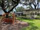 Community playground with a swing set and a gazebo, perfect for families to enjoy outdoor activities at 813 Lancer Cir, Ocoee, FL 34761